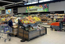 Parasite Panic Upends America’s Salad People shopping and cleaning inside an Aldi supermarket.