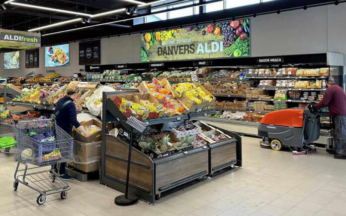 People shopping and cleaning inside an Aldi supermarket.