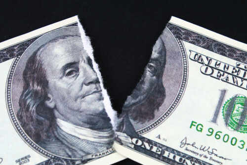Torn,Ripped,Devalued,One,Hundred,Dollar,Bank,Note,On,A A torn hundred dollar bill featuring Benjamin Franklin