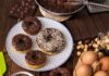 Milk Bomb in Donut Aisle Chocolate glazed donuts on a patterned plate with baking ingredients