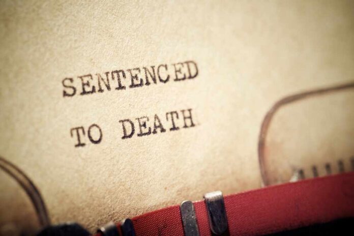Sentenced,To,Death,Text,Written,With,A,Typewriter. Close-up of a typewritten document stating 'SENTENCED TO DEATH'