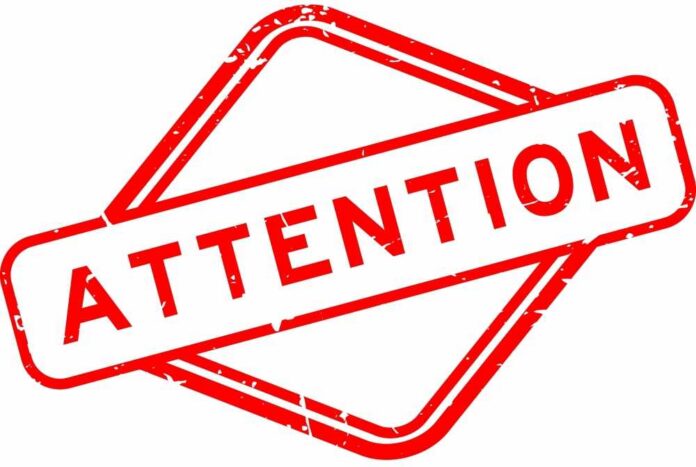 shutterstock_2292033991 Red attention sign with the word 'ATTENTION' in bold letters