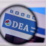 DEA Enters Hollywood Death Probe Closeup of DEA website through a magnifying glass.