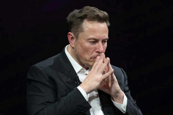 shutterstock_2318800313-1 Elon Musk in a suit deep in thought, black background.