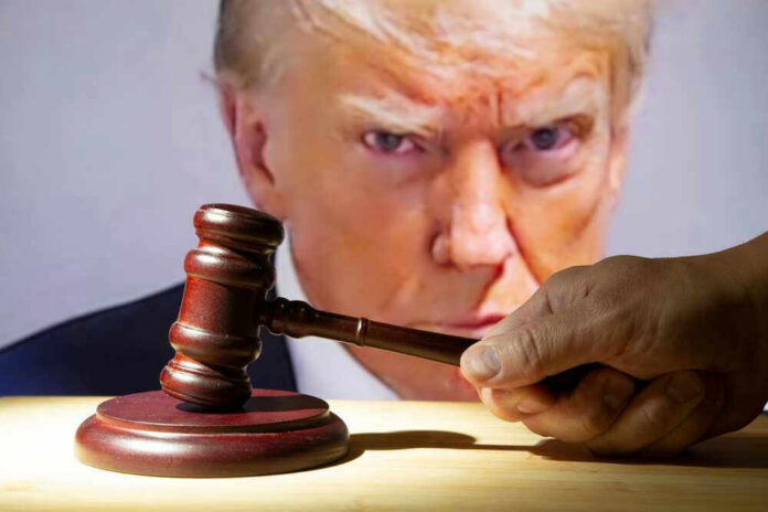 shutterstock_2362003039 Gavel in front of Donald Trumps face on screen.