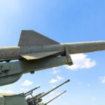 Missile on a launcher against a blue sky