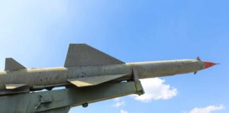 Missile on a launcher against a blue sky