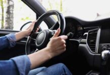Belts Fail — Big Recall Follows Hands gripping a steering wheel inside a car