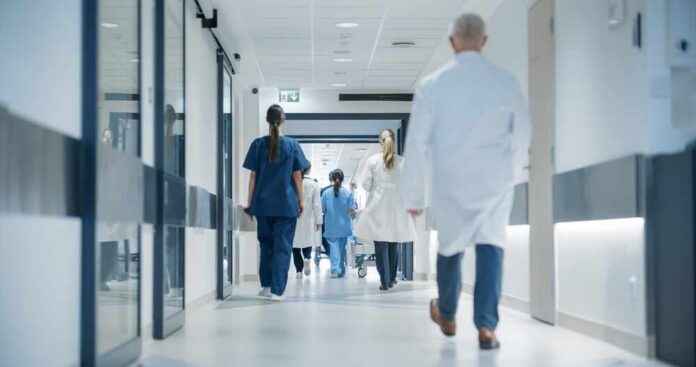 Medical staff walking through a hospital corridor