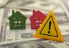 Rich Buyers Feast, Starters Stall Colorful house models and a warning sign on dollar bills