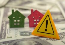Rich Buyers Feast, Starters Stall Colorful house models and a warning sign on dollar bills