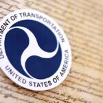 Department of Transportation logo on a historical document background