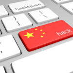 China Hackers Penetrated DOJ, Fed, Senate Keyboard key with China flag and hack label