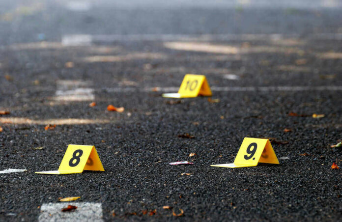 shutterstock_309339200 Yellow evidence markers labeled 8, 9, 10 on pavement.
