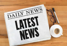 Newspaper with headline latest news on table