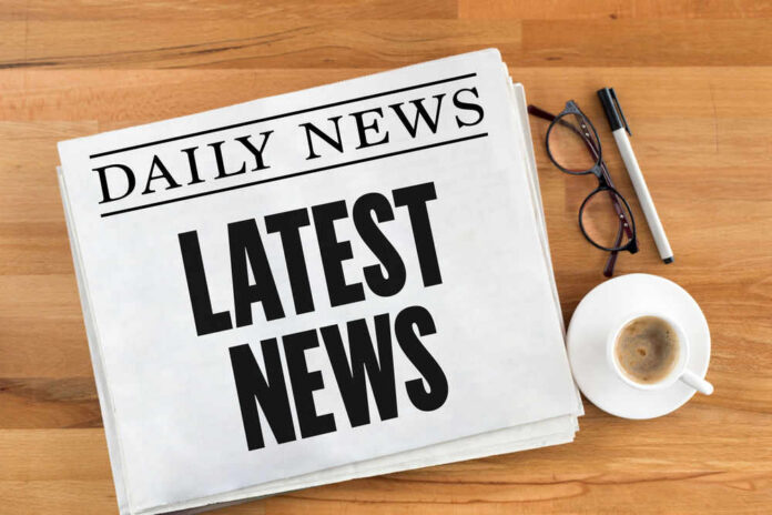 shutterstock_565653796 Newspaper with headline latest news on table