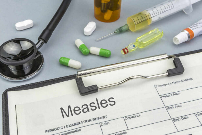 Measles,,Medicines,And,Syringes,As,Concept,Of,Ordinary,Treatment,Health Medical supplies including a stethoscope, syringes, and medication related to measles