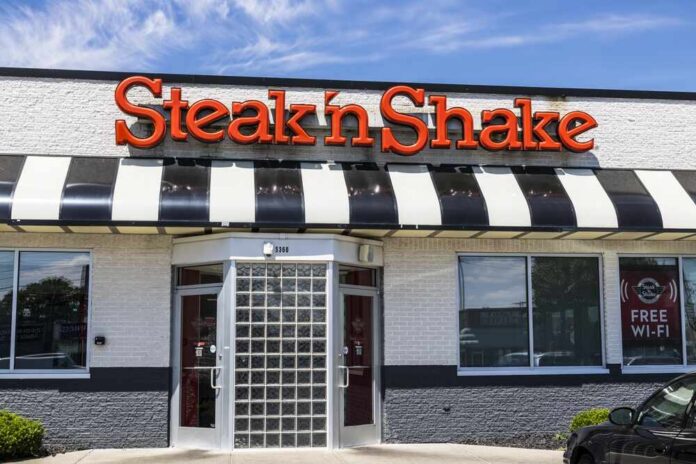 Exterior view of a Steak 'n Shake restaurant with a striped awning