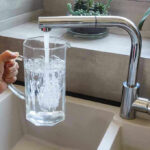 Island Water Taps Go Dark — 48 Hours Dry Hand filling pitcher with water from faucet.