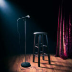 Beloved Icon Gone — Hollywood Stunned Empty stage with microphone and stool.