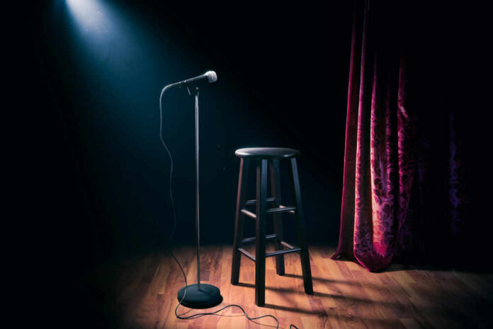 shutterstock_1031487514 Empty stage with microphone and stool.