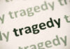 Close-up of the word 'tragedy' printed multiple times in varying shades