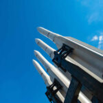 Missile launcher pointing skyward against a bright blue sky