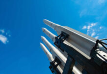 Pentagon Shortfall Bombshell Revealed Missile launcher pointing skyward against a bright blue sky