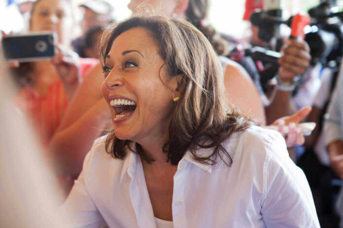 shutterstock_1444531736 Kamala Harris smiling in a crowd
