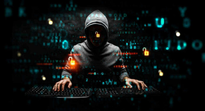shutterstock_1480095632 Hacker wearing a hoodie with digital codes overlaying.