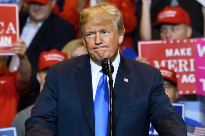 shutterstock_1515374468 Donald Trump at a rally with supporters.