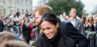 Meghan, Duchess of Sussex greets crowd with Prince Harry, Duke of Sussex nearby