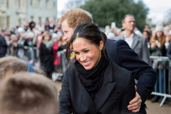 shutterstock_1559827346 Meghan, Duchess of Sussex greets crowd with Prince Harry, Duke of Sussex nearby