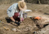 Amazing Discovery: Lost Monastery Found Under Soccer Field Archaeologist excavating skeletal remains at an archaeological site.