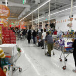 Walmart’s Decade Standoff ENDS Shoppers queue with carts in a supermarket checkout area
