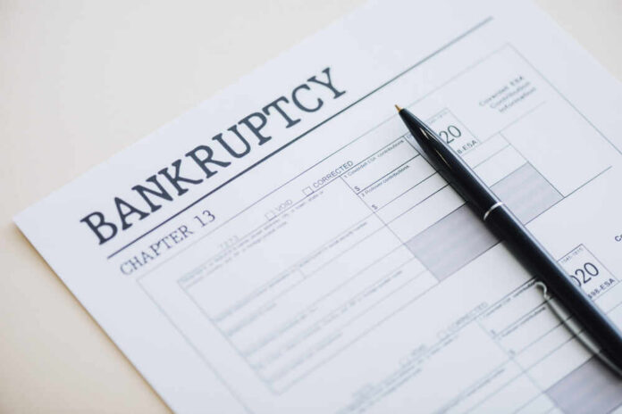 High,Angle,View,Of,Pen,On,Document,With,Bankruptcy,And Bankruptcy Chapter 13 form with a pen resting on it