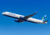 JetBlue Airbus A321 climbing against a clear blue sky