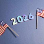 Deep-Red State STUNNER? Two small American flags next to the numbers 2026 on a blue background