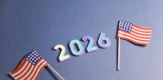 Two small American flags next to the numbers 2026 on a blue background