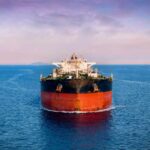 Oil tanker ship on open sea at dusk