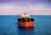 Oil tanker ship on open sea at dusk