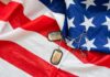 Military Purpose for Trump’s Arch Revealed Dog tags on an American flag
