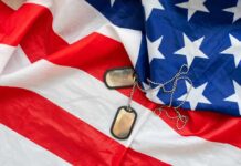 Military Purpose for Trump’s Arch Revealed Dog tags on an American flag