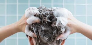 Person washing hair with shampoo lather
