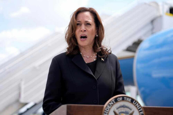 shutterstock_2497959729 Kamala Harris speaking in front of airplane stairs.
