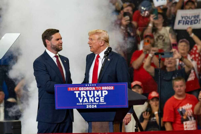 shutterstock_2499200129 A political rally featuring Donald Trump and JD Vance.