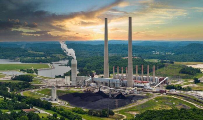 Thermal,Power,Plant,Burning,Coal,Fossil,Fuel,For,Production,Of Coal-fired power plant with tall smokestacks at sunset
