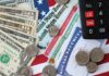 Paychecks Pop: New Record Shocks D.C. Various denominations of U.S. currency and financial documents on a flag background
