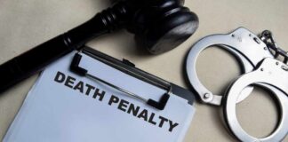 Clipboard with death penalty document beside gavel and handcuffs