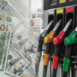 Six-Dollar Diesel, Americans Slammed Again! Fuel pump nozzles next to spread of U.S. hundred-dollar bills